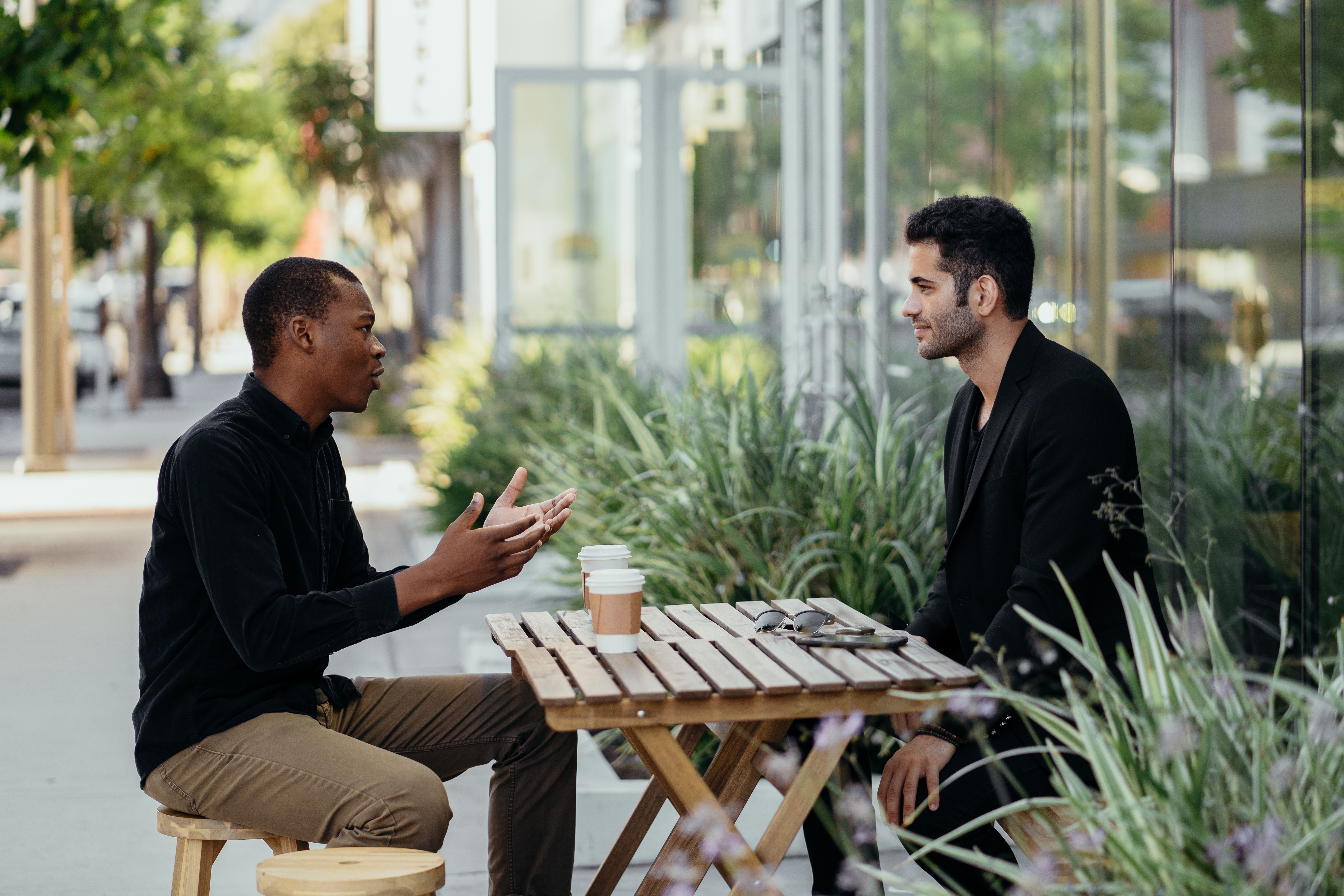 Two people talking, mid-conversation. Not posed